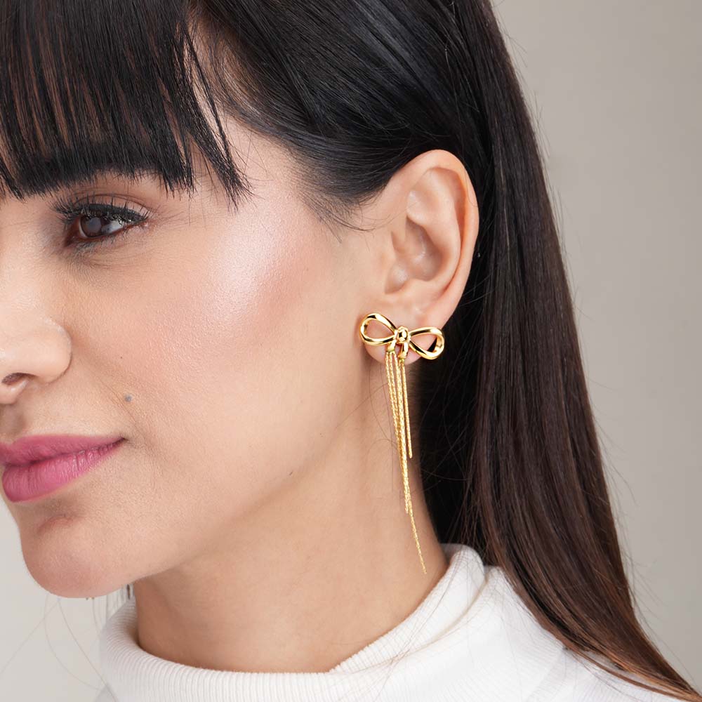 Gold bow and tassel dangler earrings